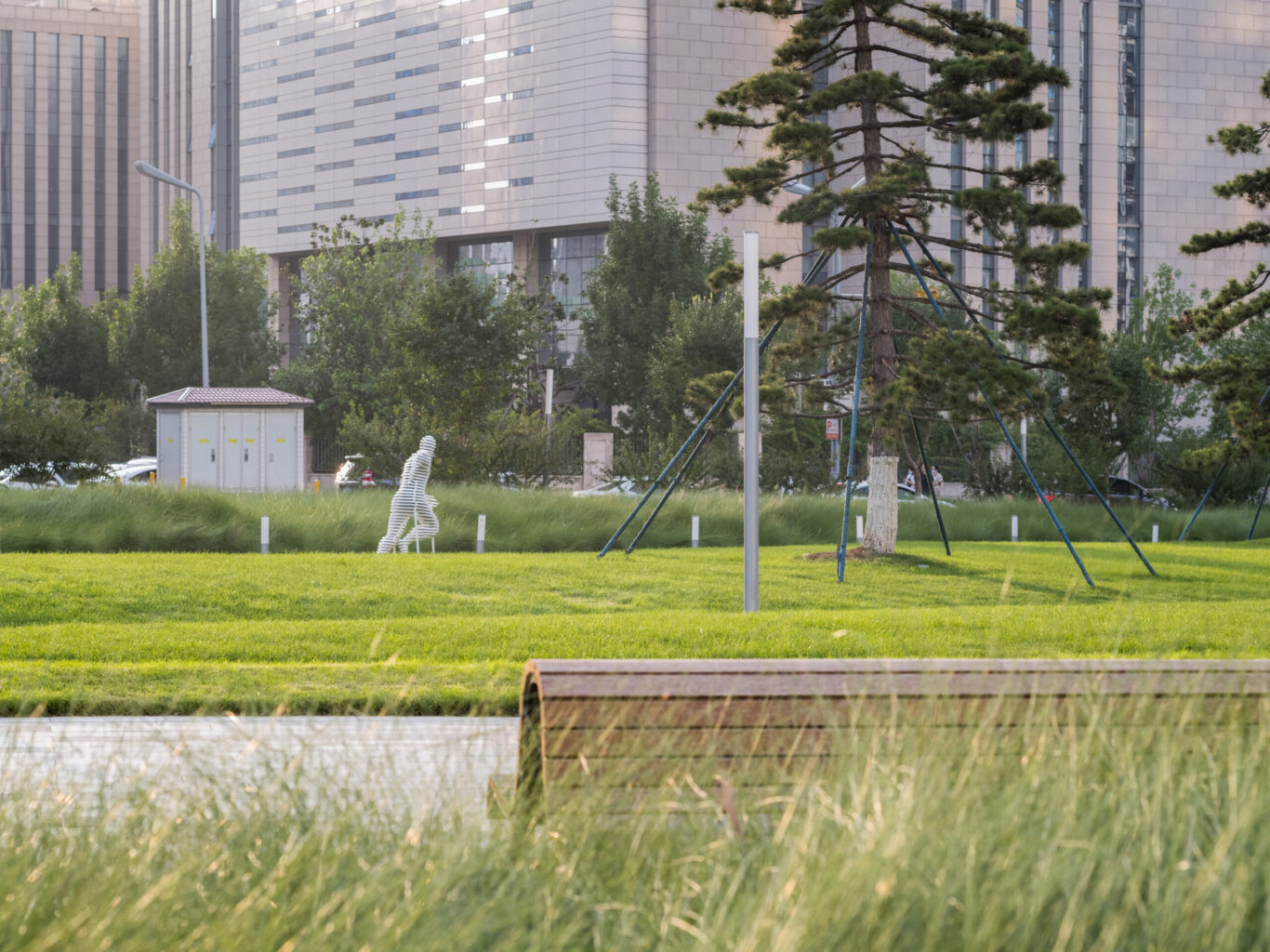 Slide 3 of 4, View of sculpture of man running in Jinan Ribbon Park.