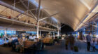 Interior view of the concourse gate lounges. A curved roof profile minimizes heating and cooling needs in the building, filtering daylight or reflecting artificial light to help align with the body's natural rhythms. High-performance mechanical and electrical systems further reduce energy use and greenhouse gas emissions.