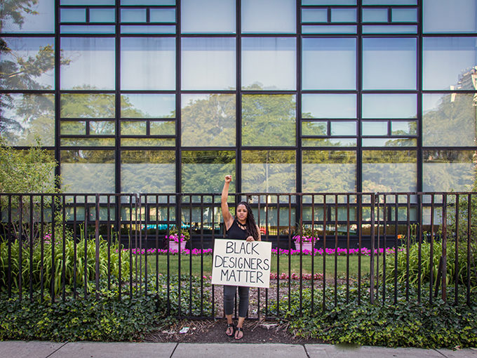 Slide 8 of 9, Urban designer Tiara Hughes in front of the AKA Headquarters building designed by Black architect John Moutoussamy.