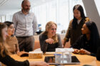 Photograph of Mina Hasman and wider SOM team within SOM's London office
