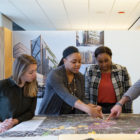 Women pointing at diagram on a map