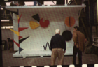 Alexander Calder and Bruce Graham look at a sculpture model for "The Universe"