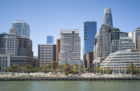 One Steuart Lane, surrounded by a mix of masonry and glass buildings, overlooks San Francisco's Embarcadero waterfront.