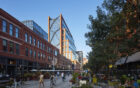 Office tower with stepped terraces sitting on a busy historic streetscape.