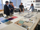 A group of five people discussing around a table in an office