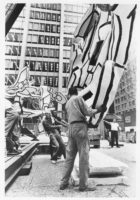 Workers install a large sculpture